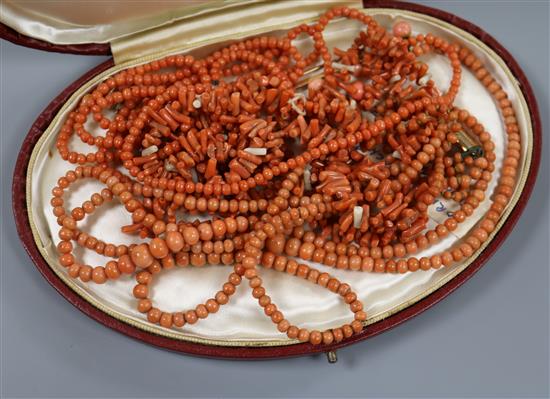 A group of assorted coral jewellery, including necklaces.